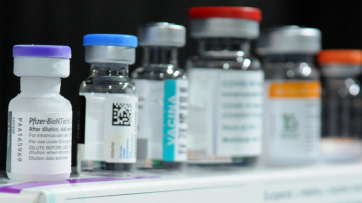 Bottles of COVID vaccine are lined up on a box
