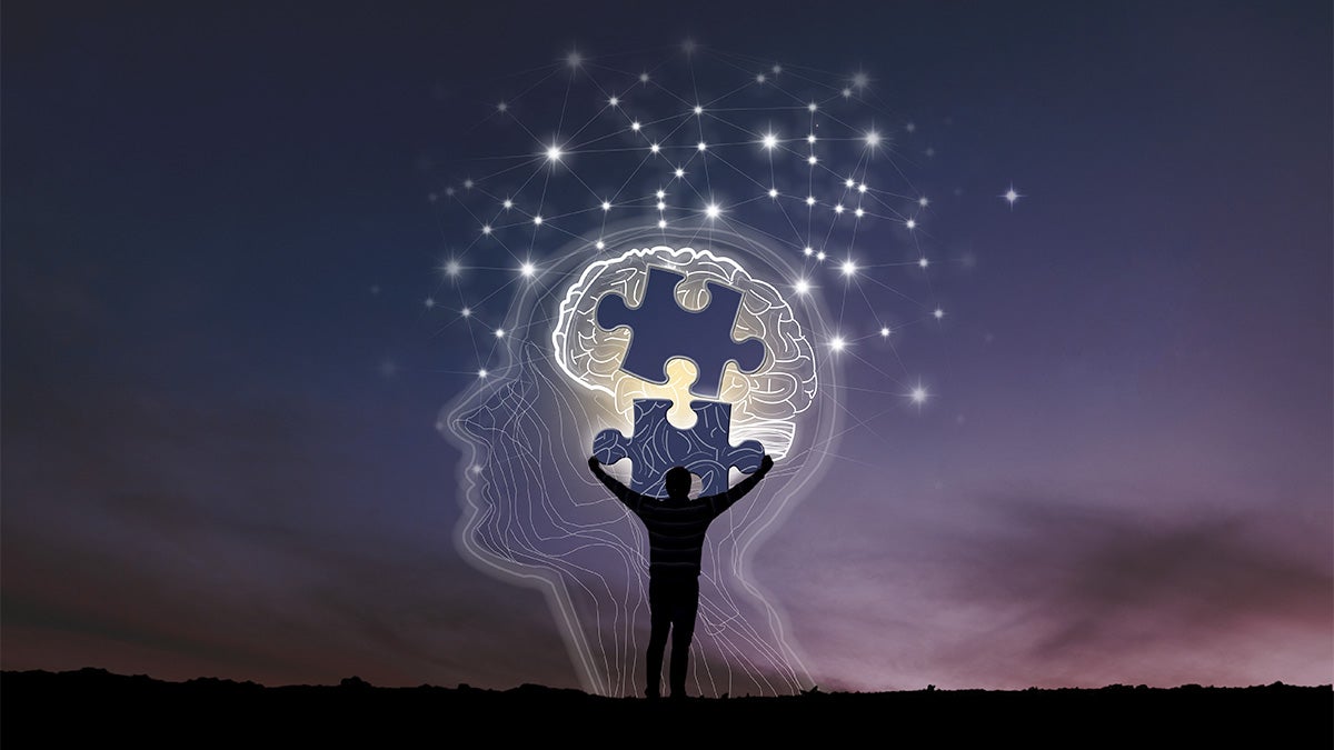 A figure stands in the twilight, arms outstretched, in front of an illustration of a head in profile with a missing puzzle piece signifying Alzheimer's disease