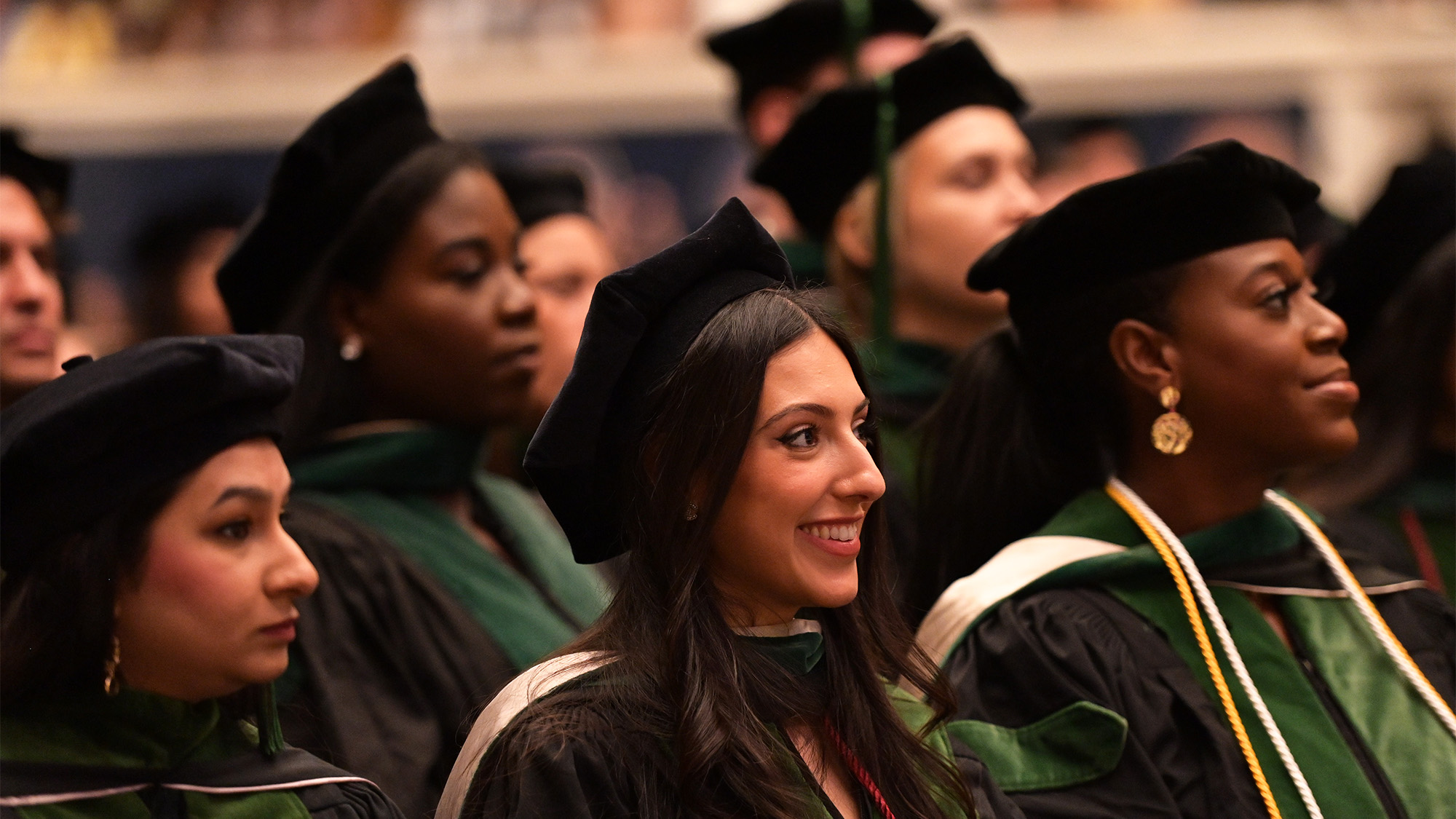 School of Medicine students sit in their commencement garb