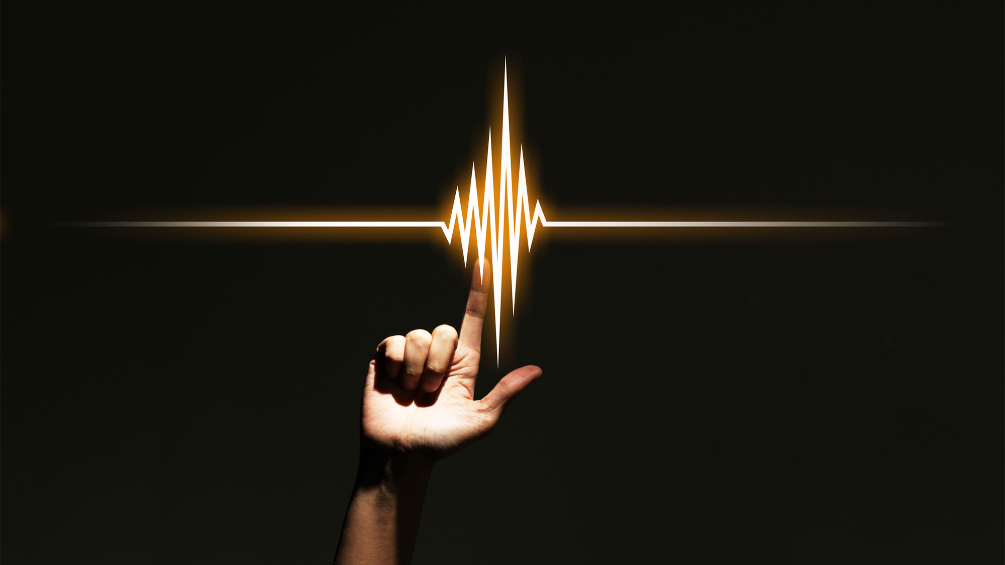 A photoillustration depicts a hand with index finger extended overlaid with the image of a light or soundwave