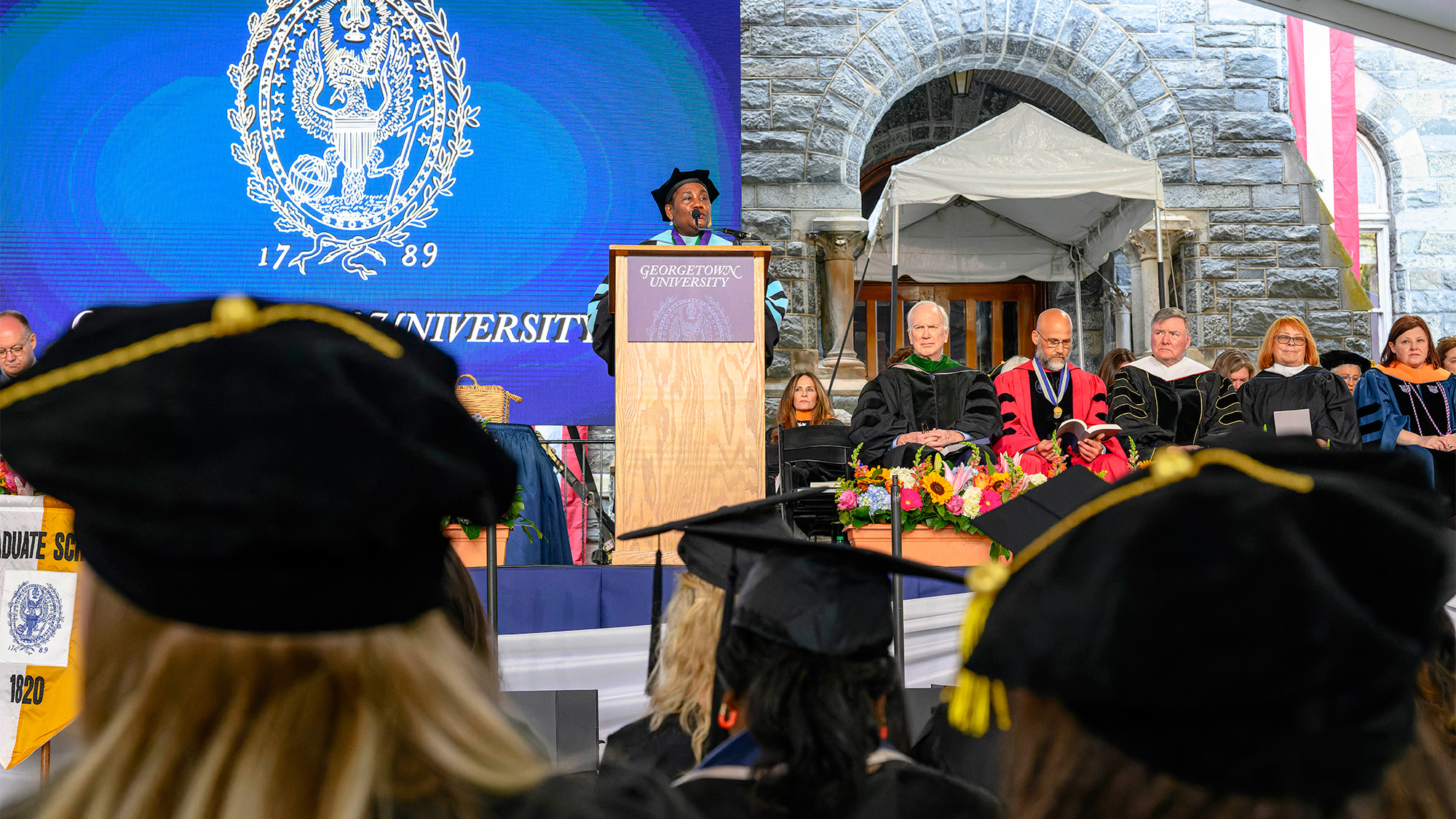 Dean Roberta Waite speaks from the podium at commencement