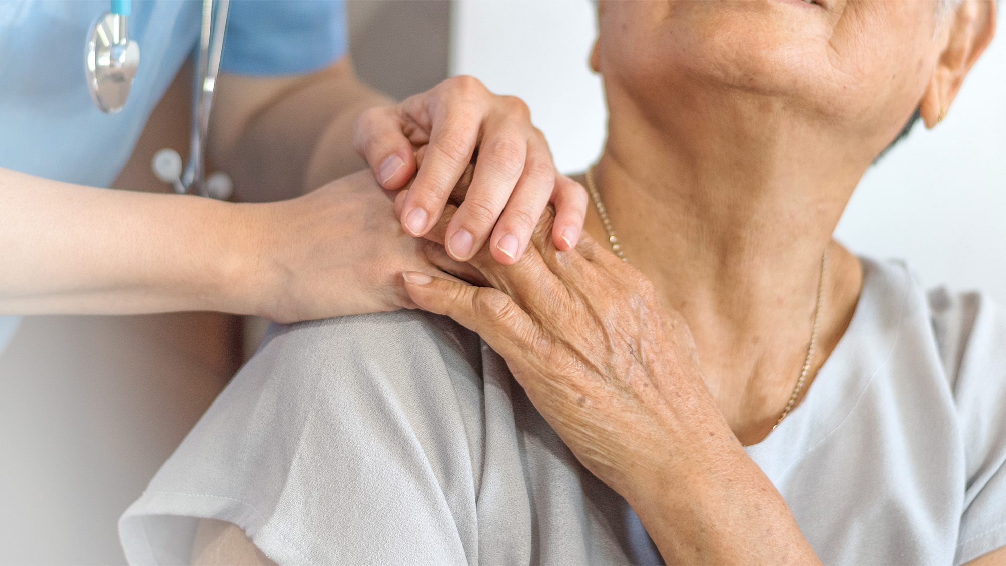 A caregiver comforts a patient