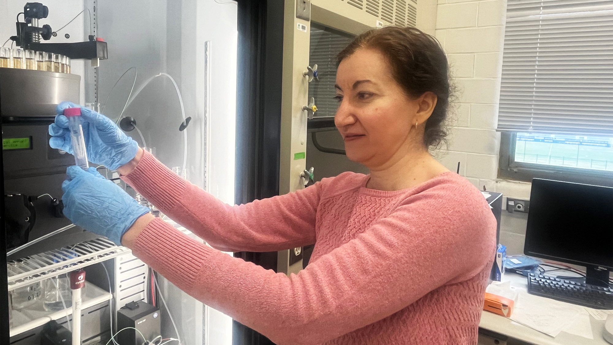 Dr. Brelidze works next to a hood in her lab