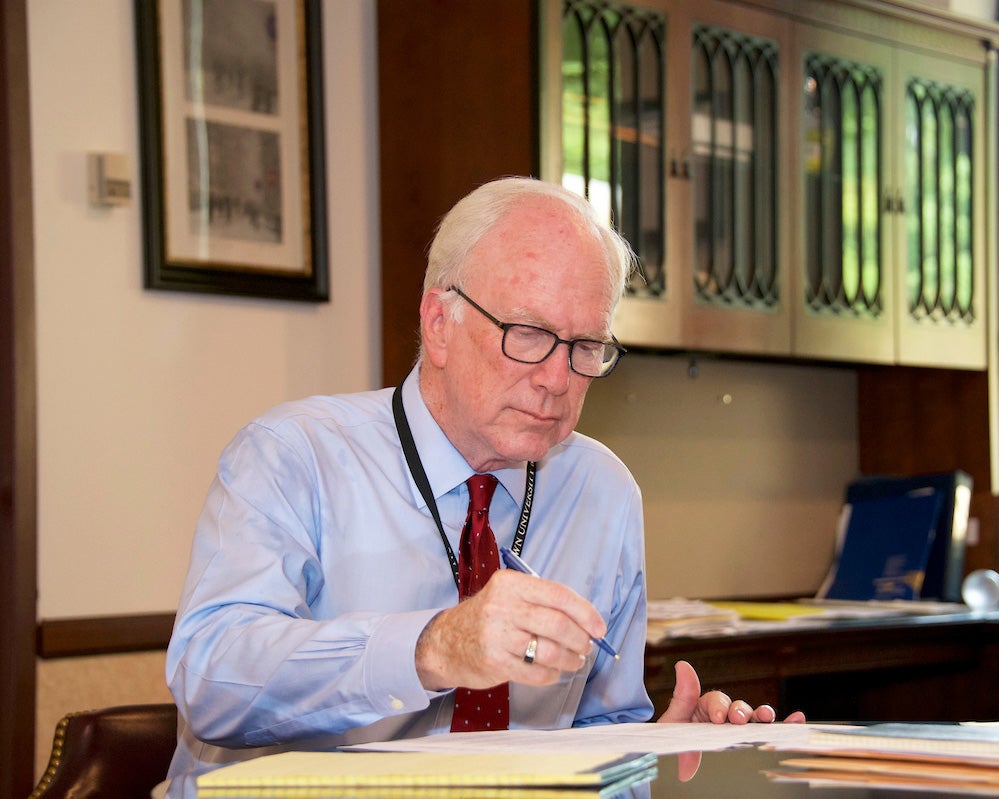 Dr. Healton works at a desk