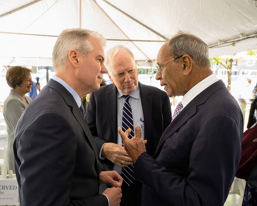 Three individuals talk together