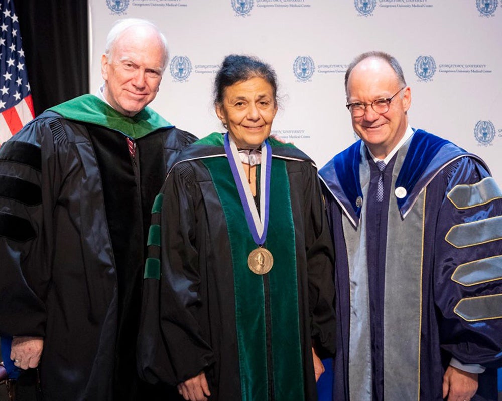 Ed Healton, Wafaa El-Sadr and Jack DeGioia stand side by side onstage