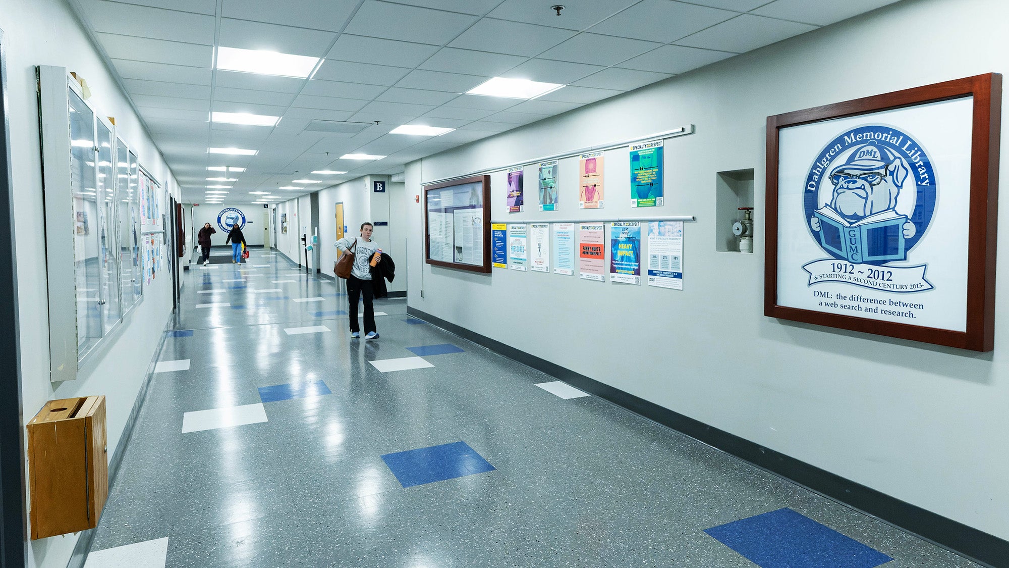 An interior hallway lined with posters and signs