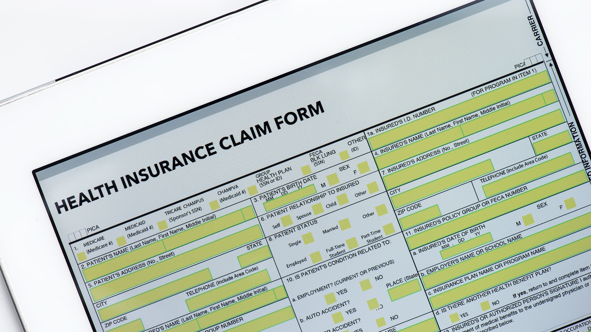 A tablet with an unfilled health insurance claim form on its display