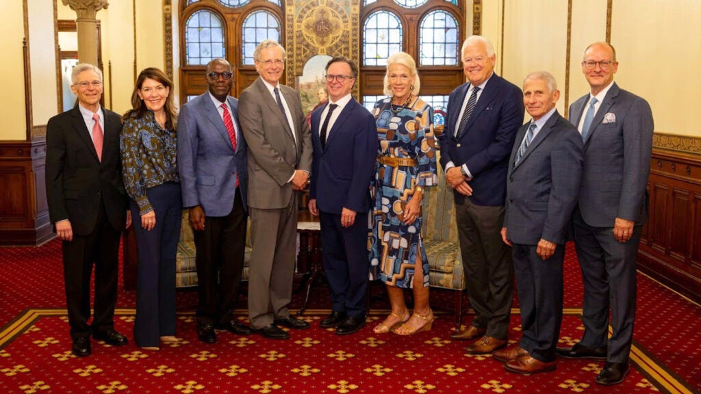 A group of nine people stand together