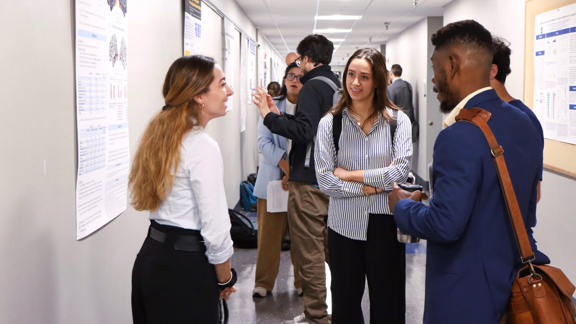 Students converse in a hallway during Student Research Day
