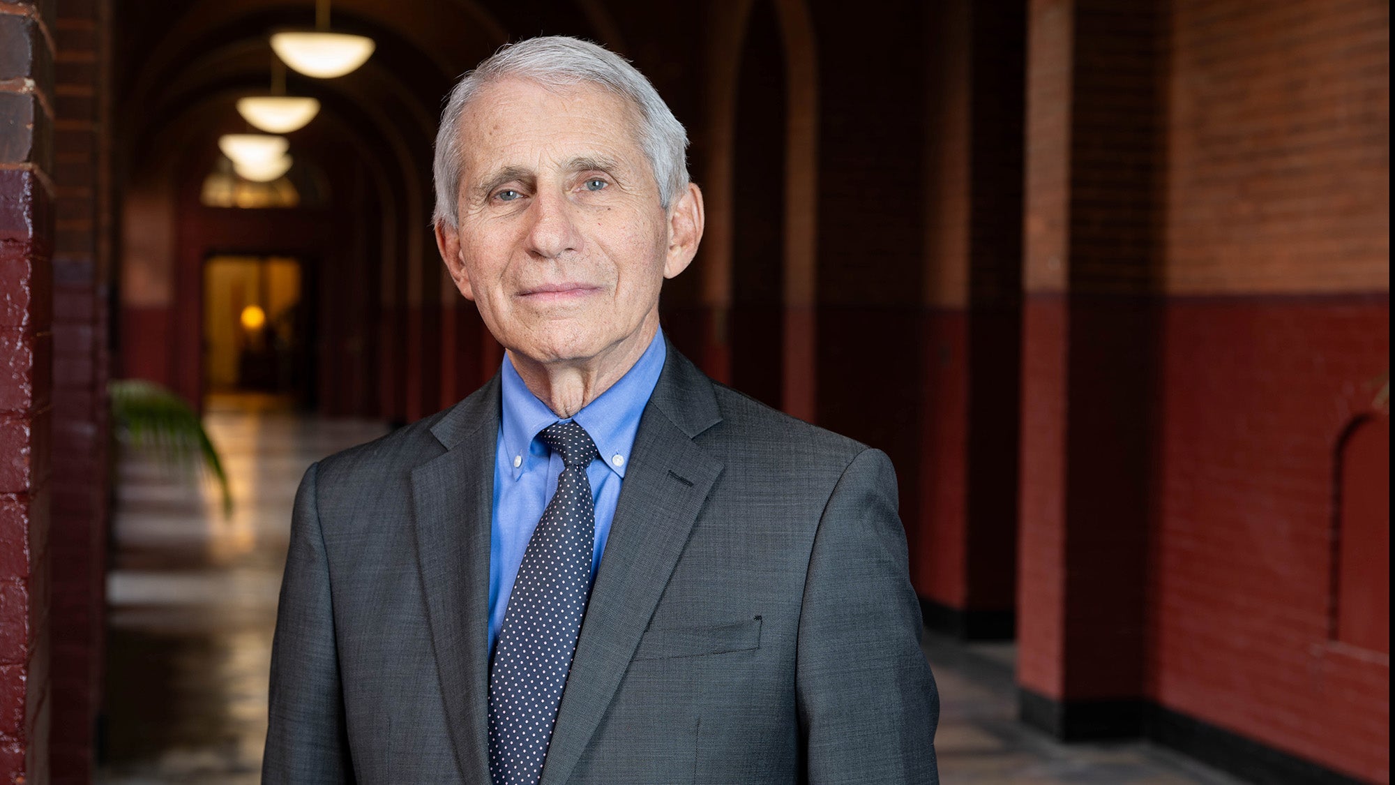 Anthony Fauci, MD, stands in a hallway at Georgetown University