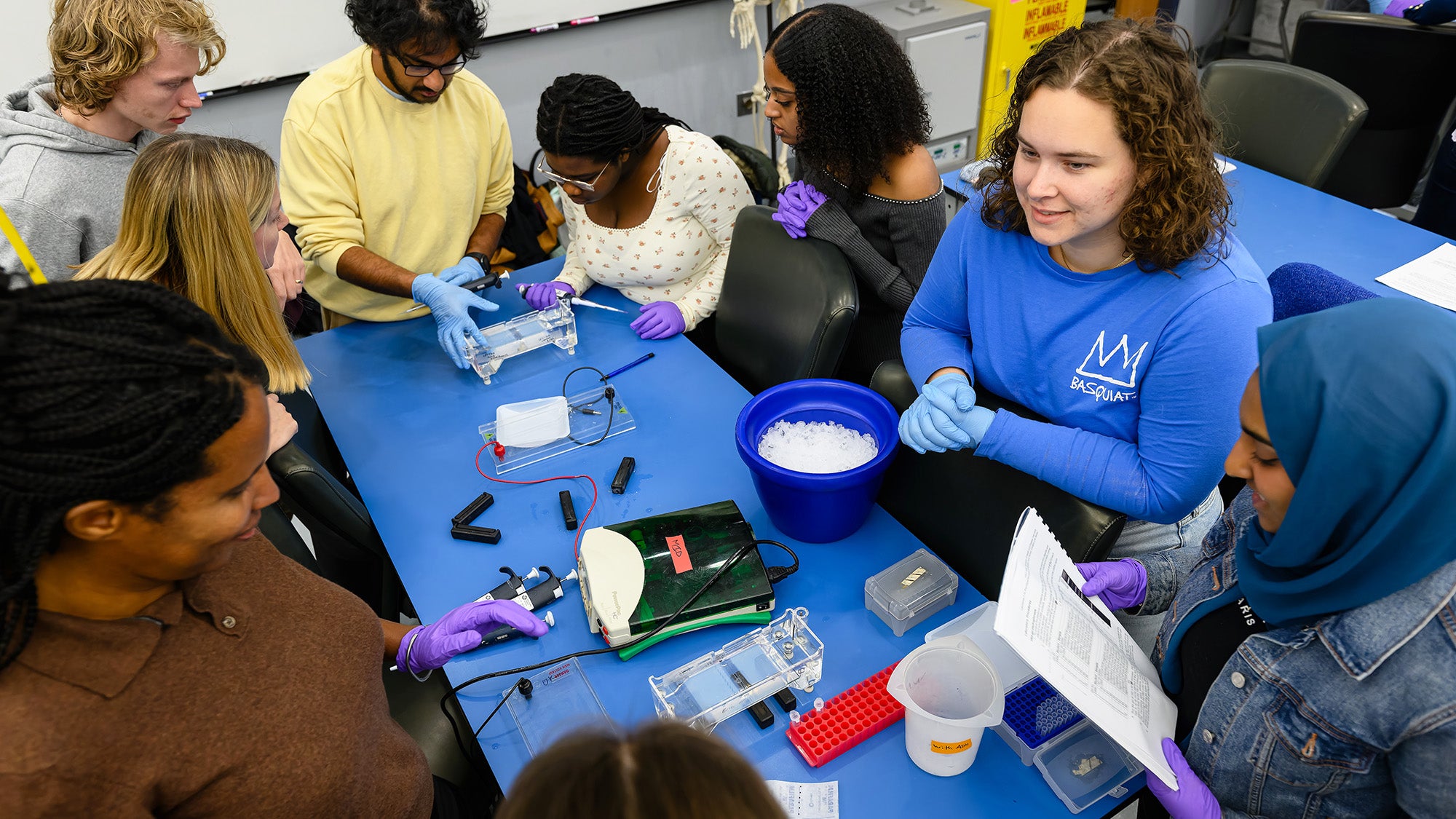 Students work on an assignment at a table in the Discovery Center lab