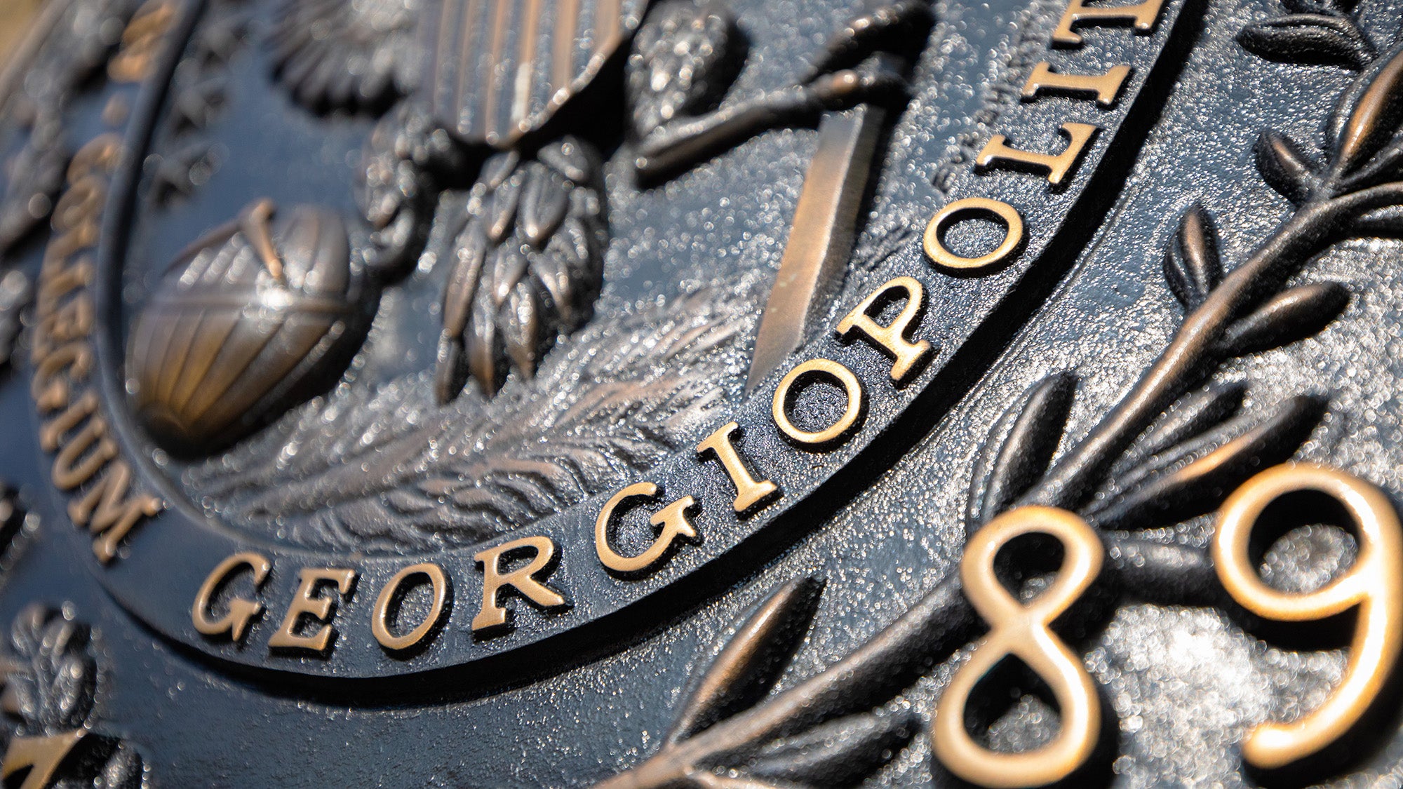Closeup detail of the GU Seal in bronze