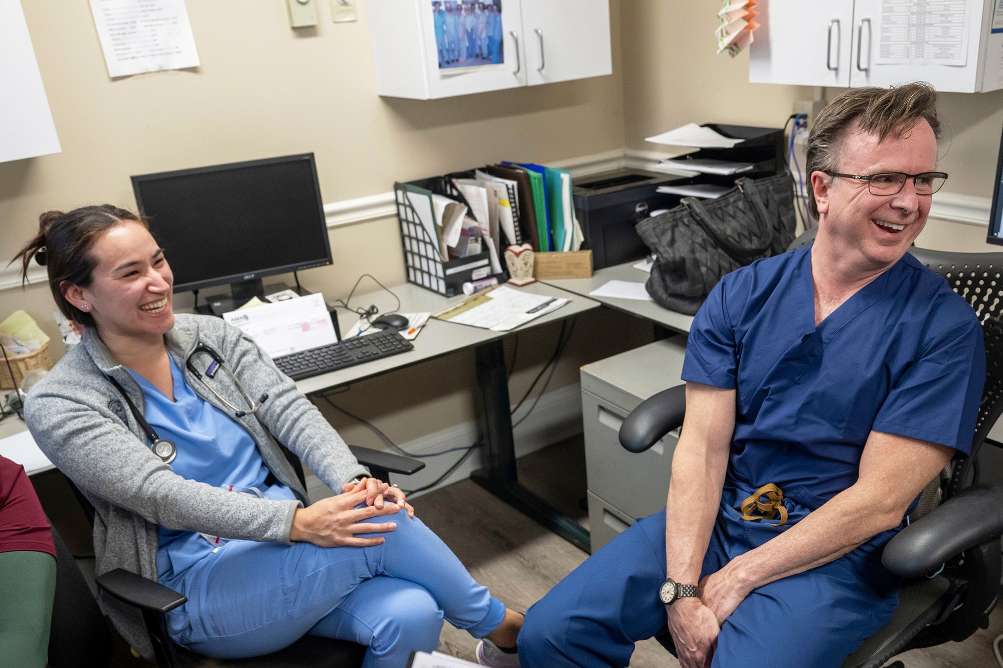 A med student shares a laugh with Dr. Norm Beauchamp
