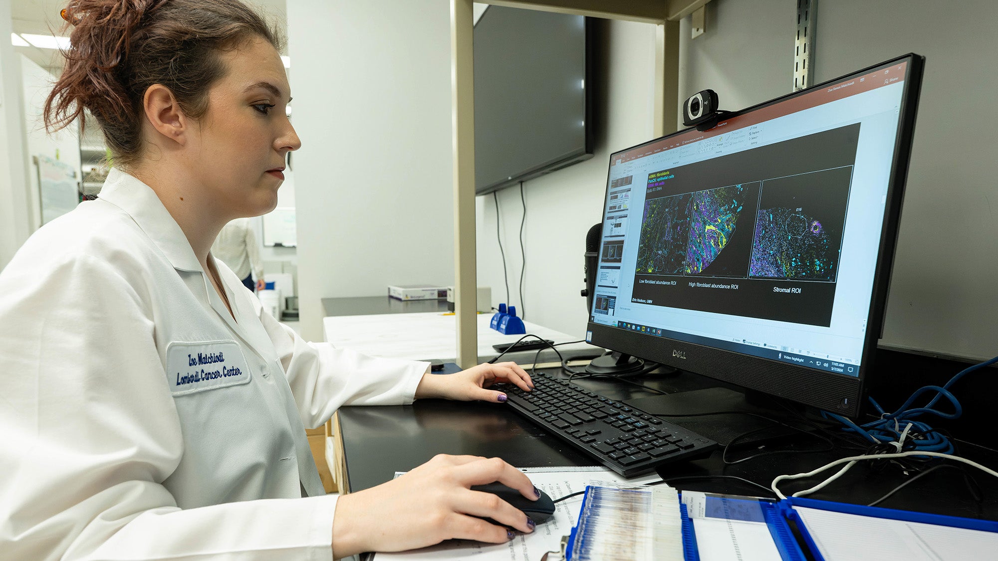 A female researcher works at a computer