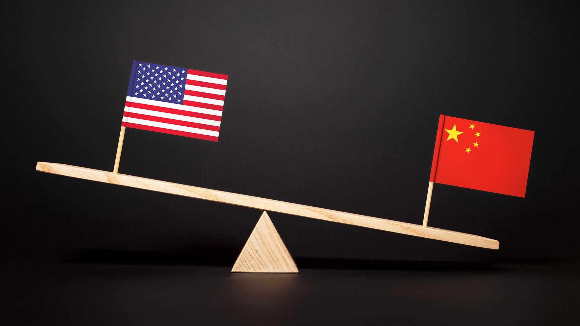 The U.S. flag is higher on a teeter totter than the Chinese flag