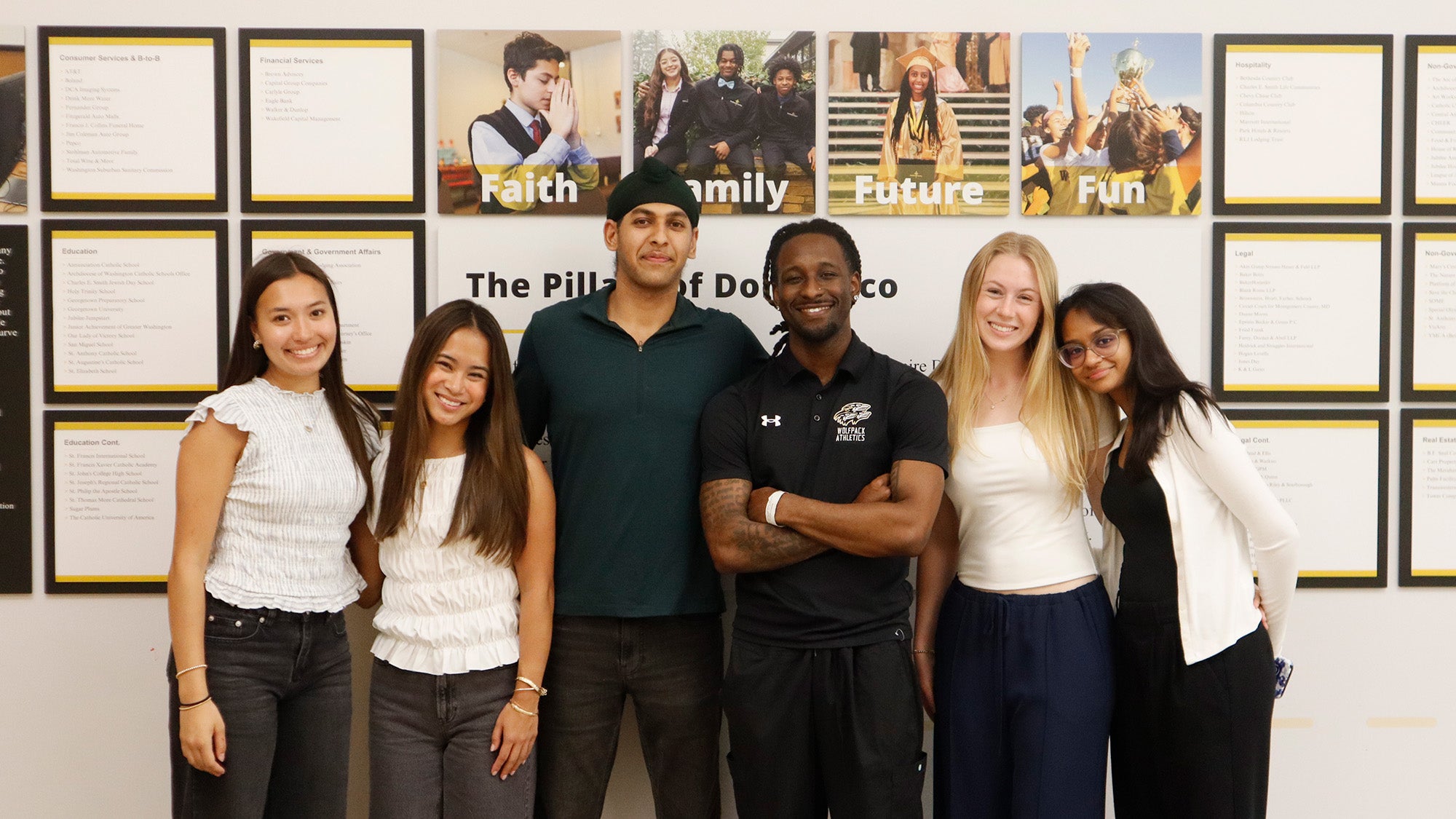 A group of Georgetown students and a teacher from Don Brisco high school stand together