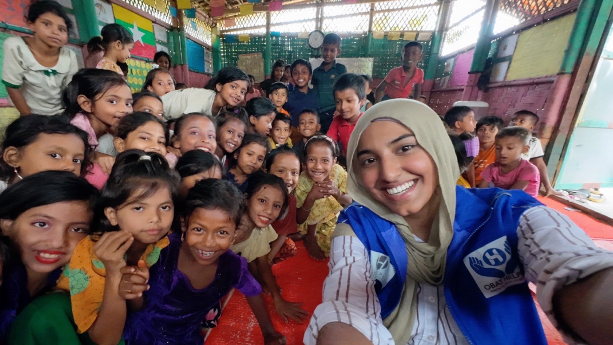 School of Health student Isra Satiar takes a selfie with children in the Rohingya refugee camp
