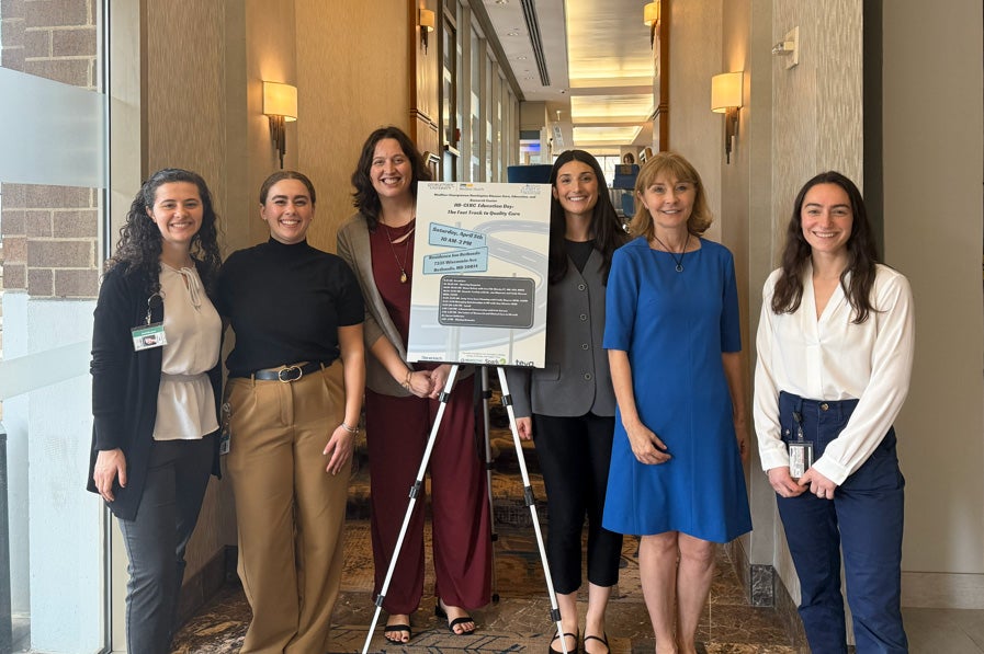 Karen Anderson stands with her HD-CERC team at a conference