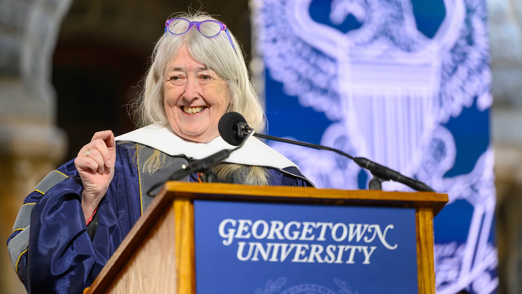 Mary Beard speaks from a podium