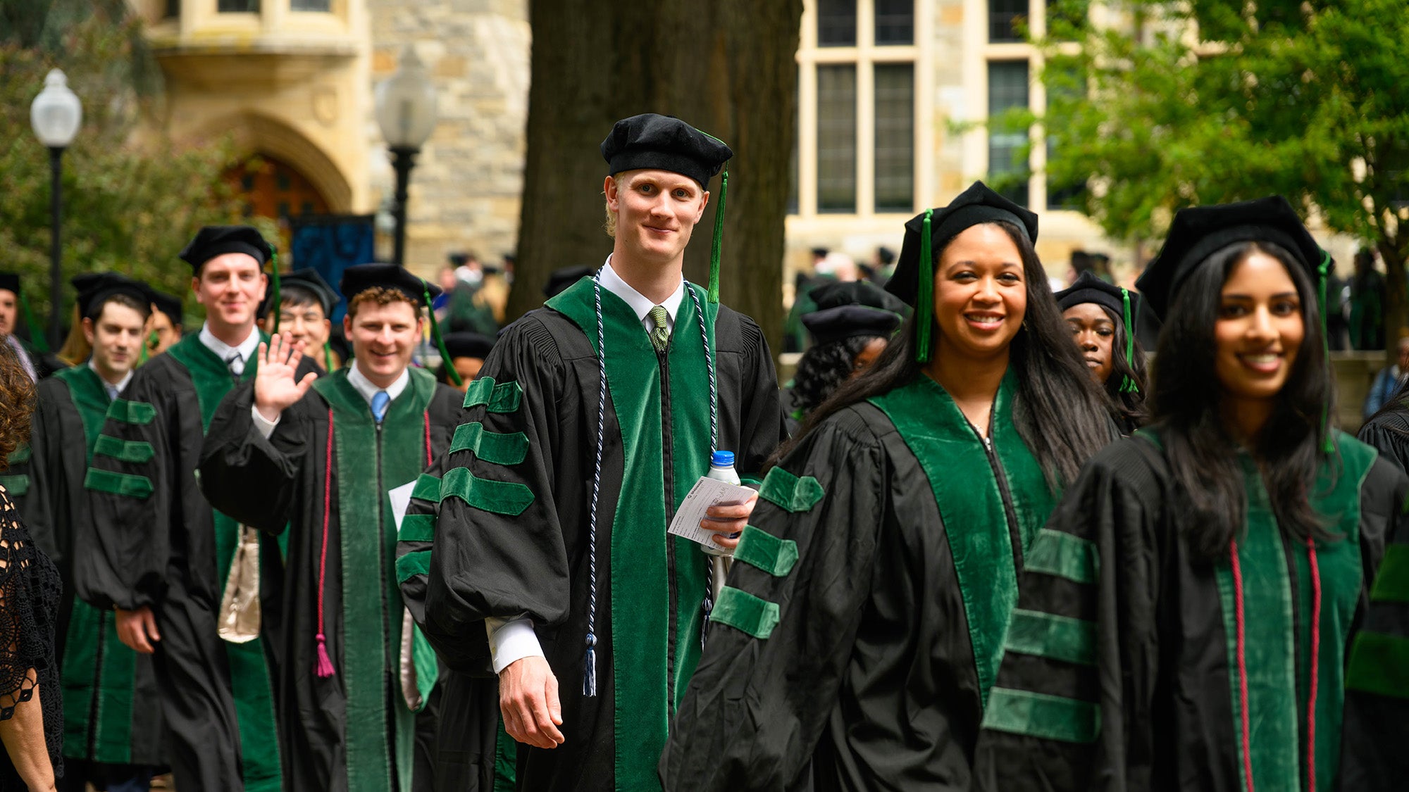 Med students walk across campus to Commencement