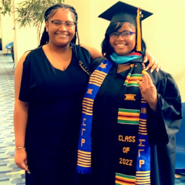 Aleria in cap and gown with her daughter