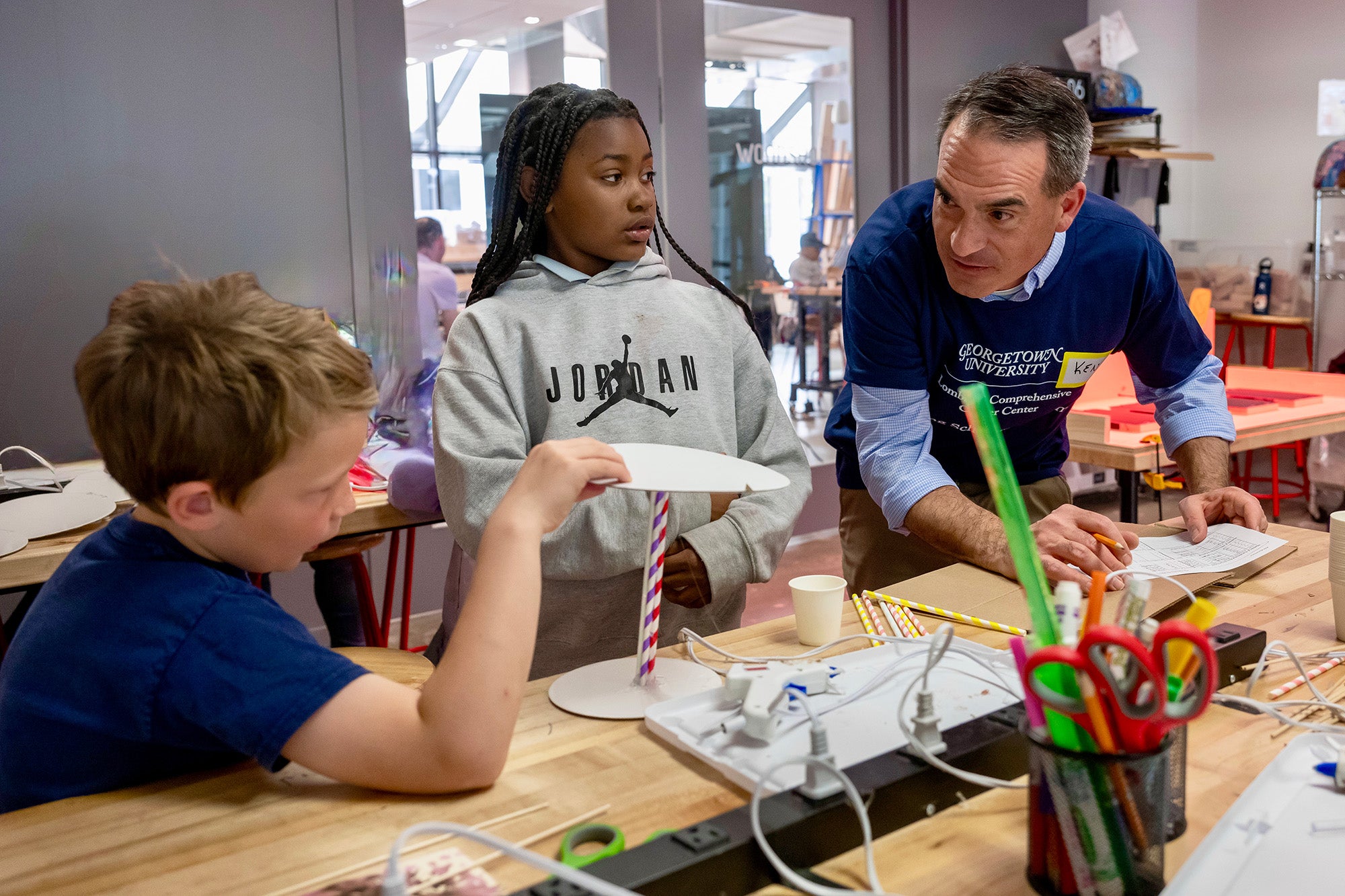 Dr. Tercyak interacts with two young participants in the Young Scholars Program
