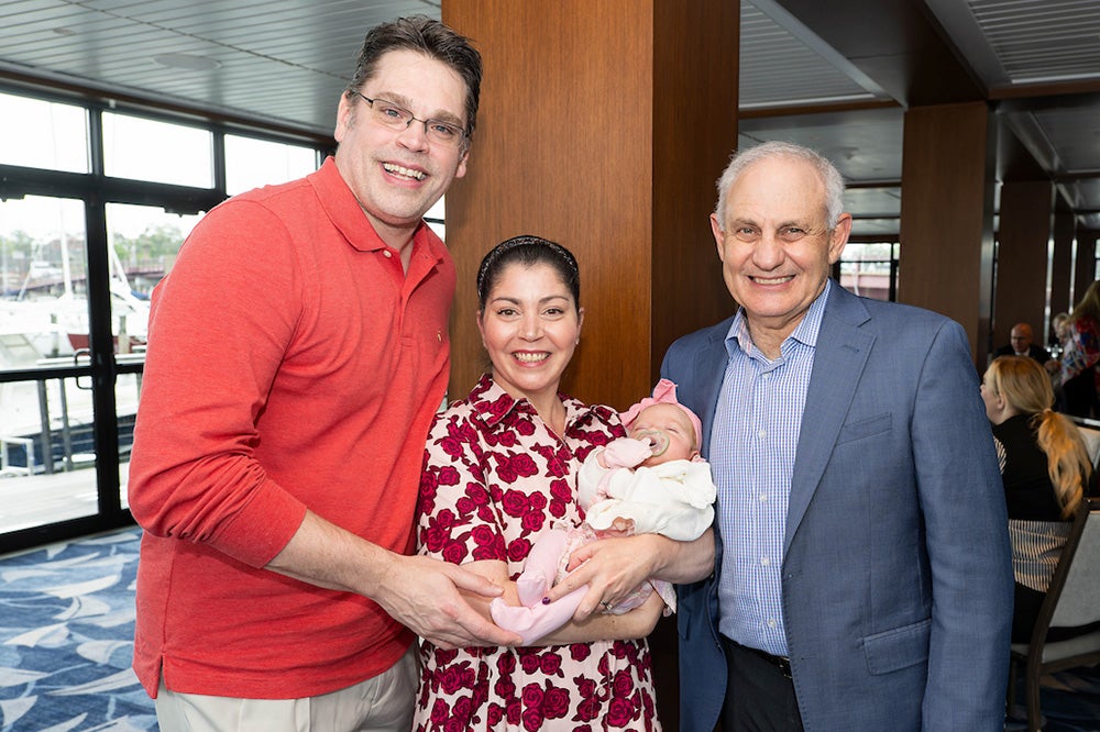 The Moes with baby stand with Dr. Atkins
