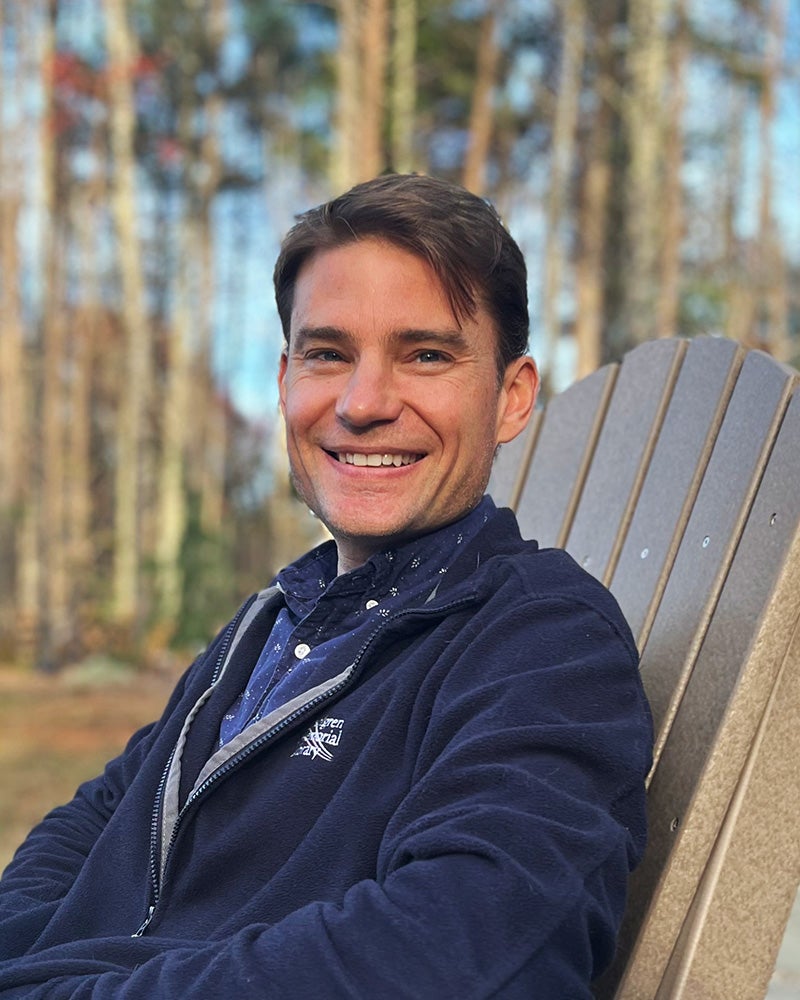 Scott Dorris seated in an Adirondack Chair