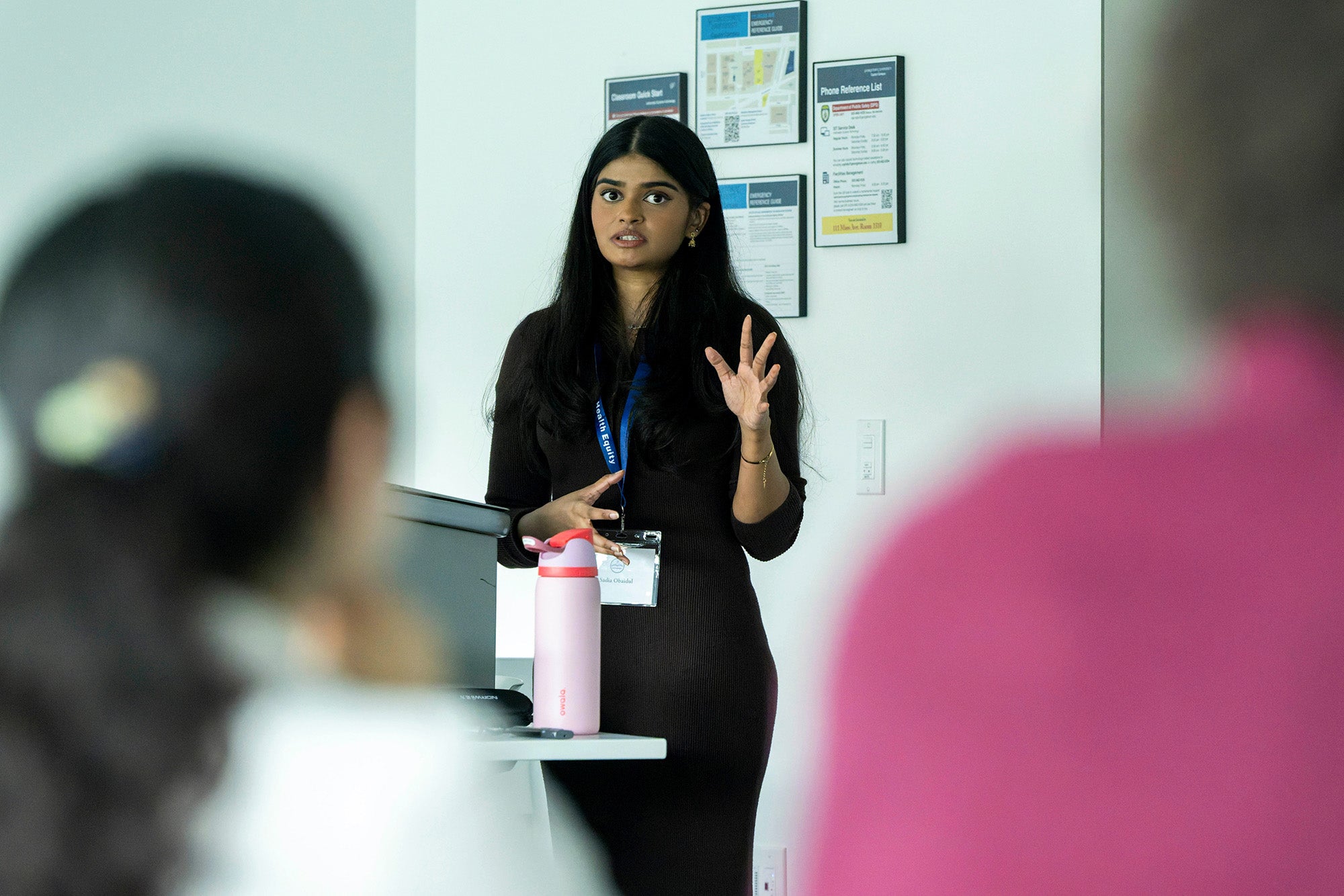 Sadia speaks before a room of attendees